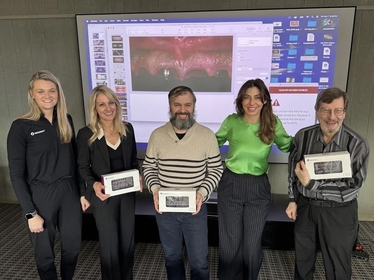Study club members with speaker gifts in front of a monitor